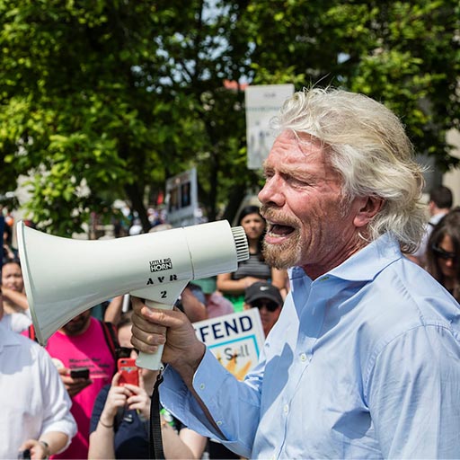Richard Branson with a megaphone at an environmental protest