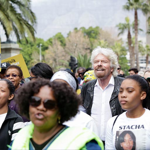 Richard Branson marching in a crowd at an Elders event